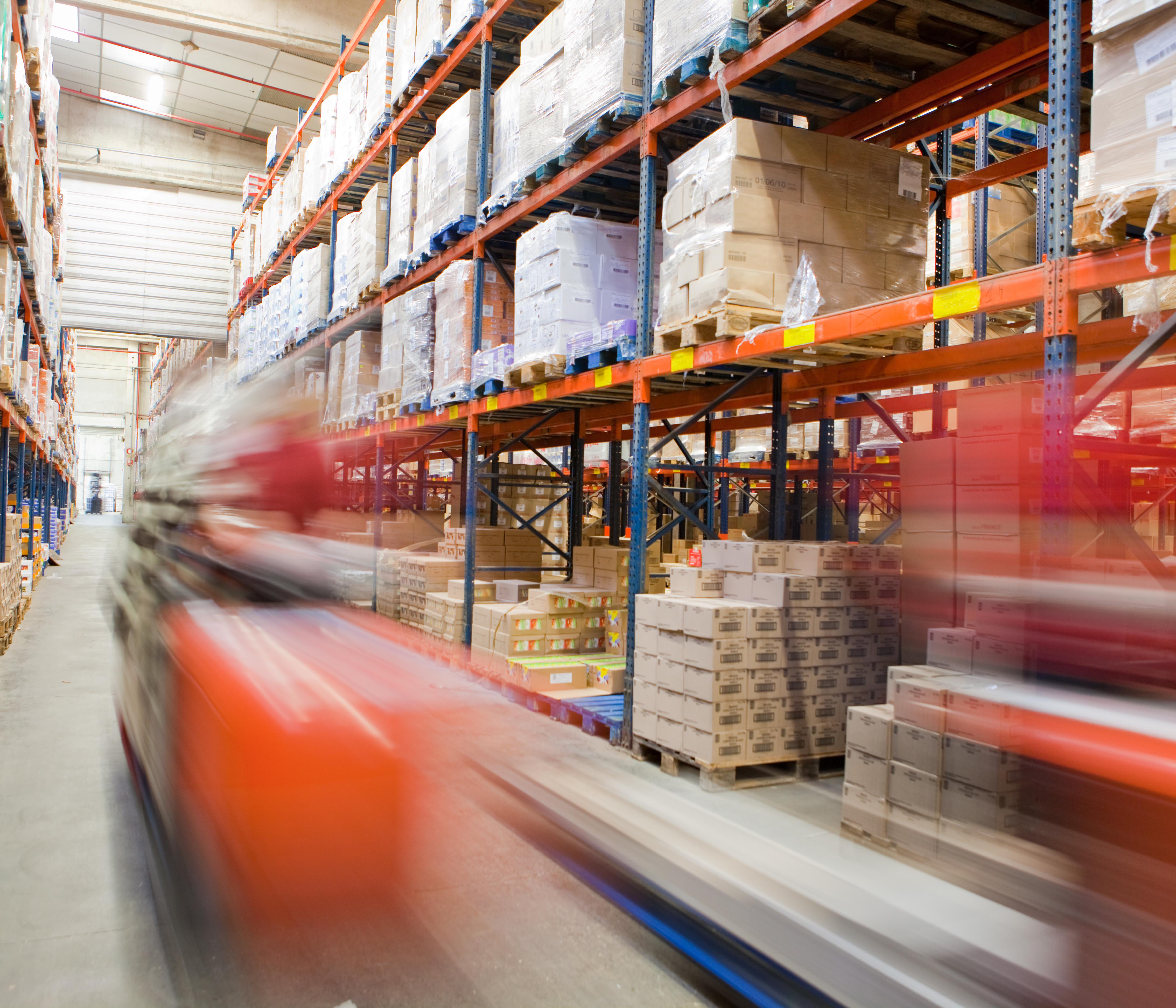 Logistics - A moving forklift in a warehouse