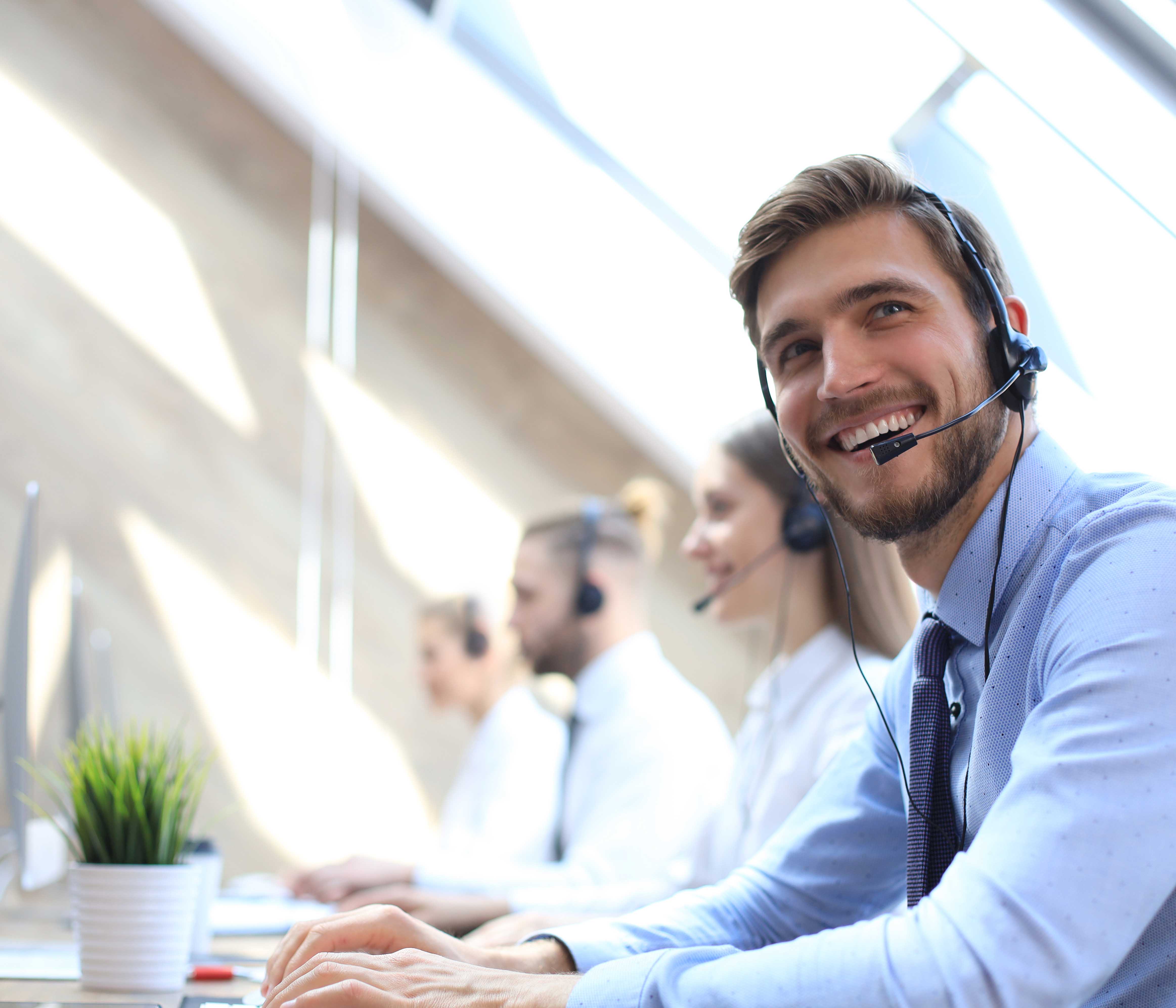 Professional Services - A smiling man working at a desk